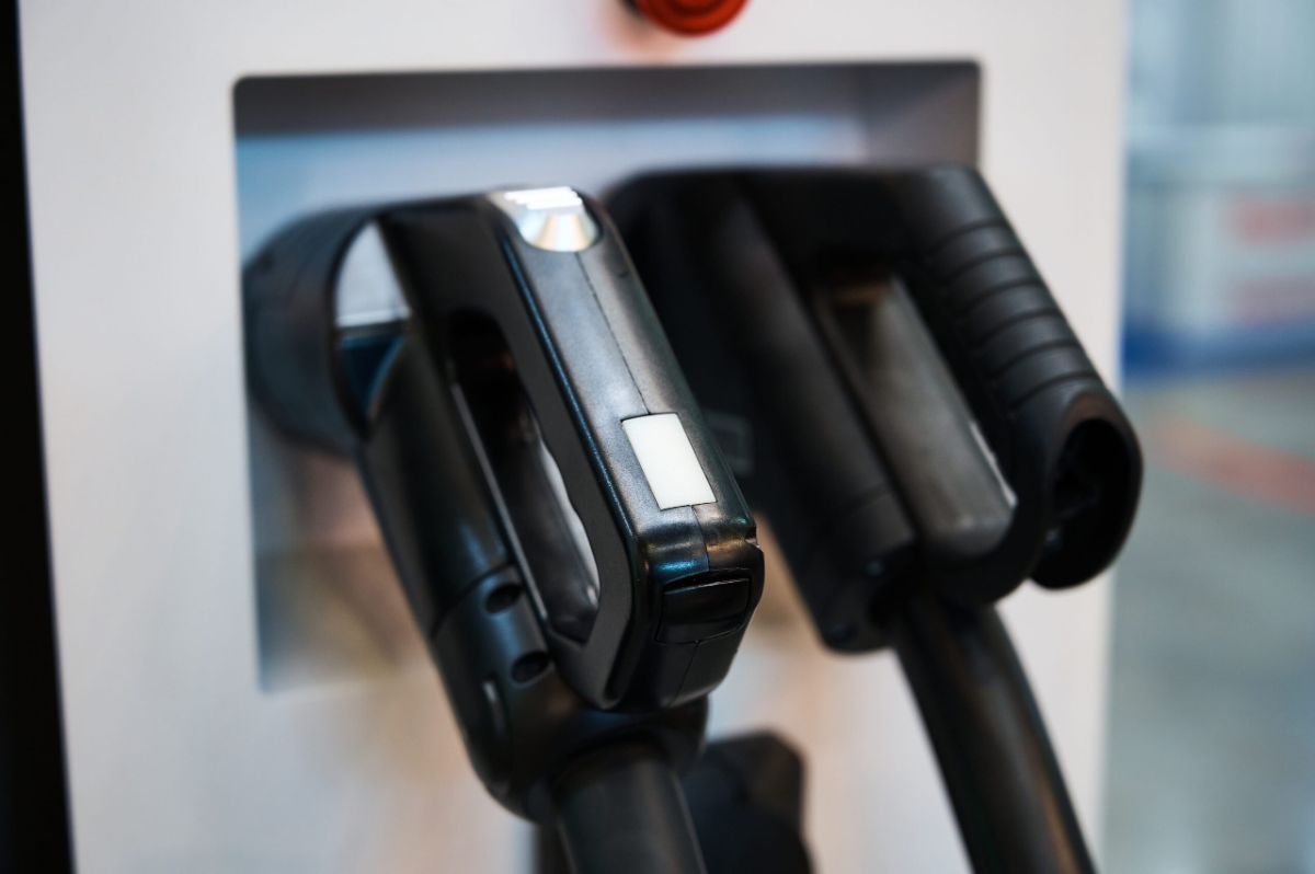 Two DC fast-charging handles resting in the holsters of an electric vehicle charging station