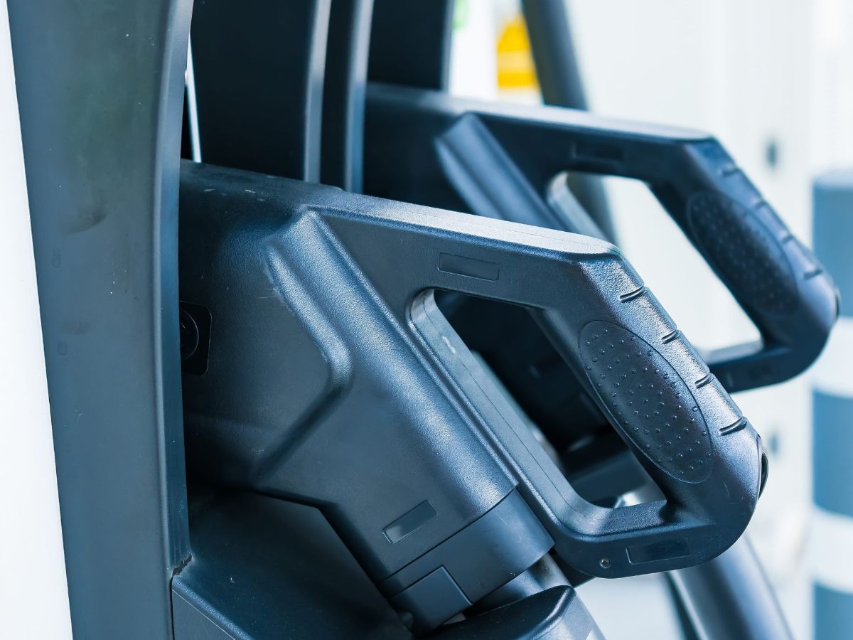 Close view of a DC fast-charging plug holstered in an electric vehicle charging station
