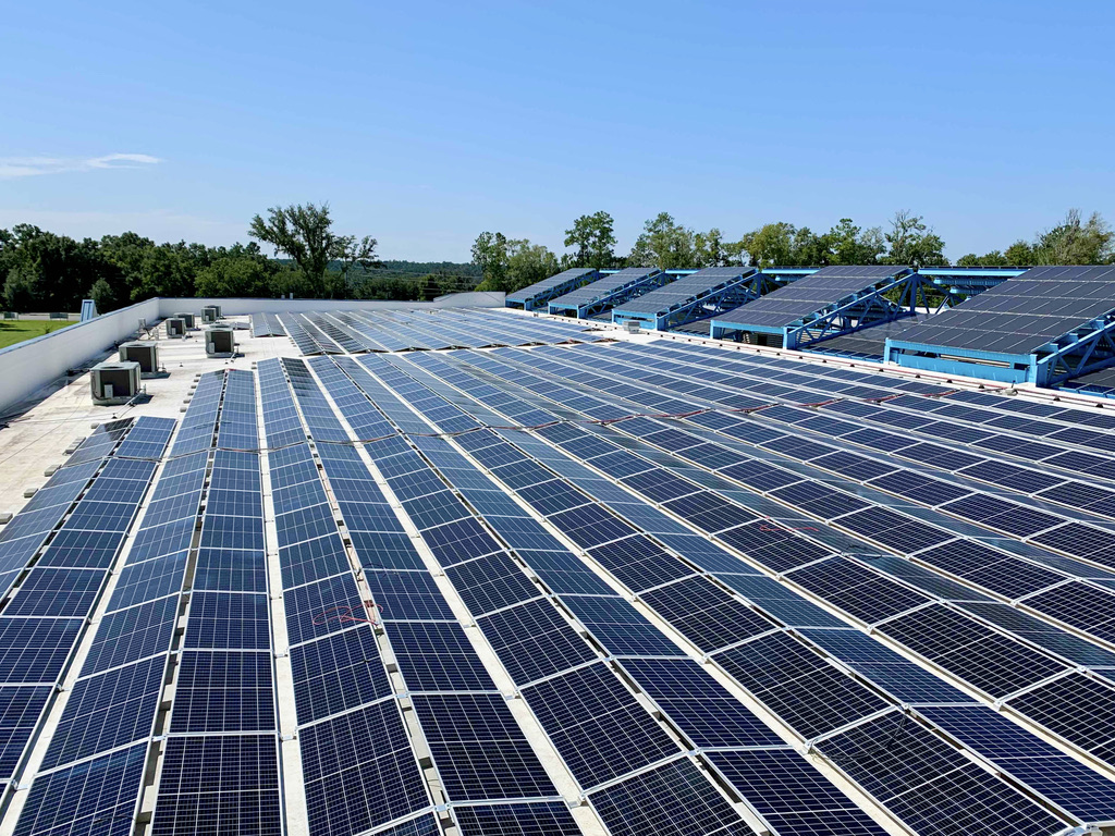 Rows of solar panels covering a large commercial flat roof