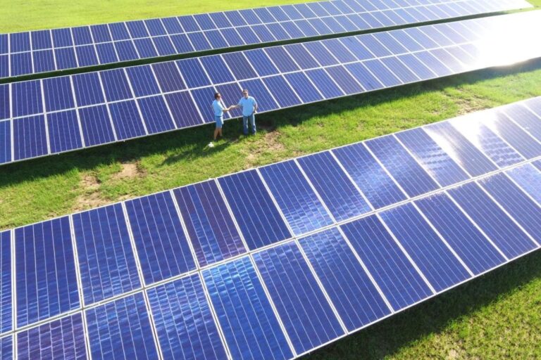 PPM Solar installers working on a commercial rooftop solar array