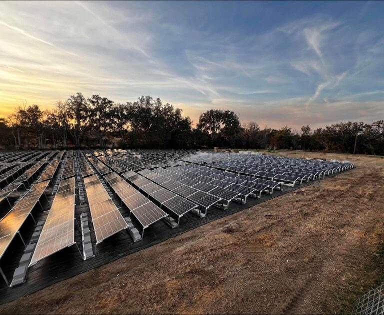 Ballasted ground-mount solar array at DeConna Ice Cream at sunset
