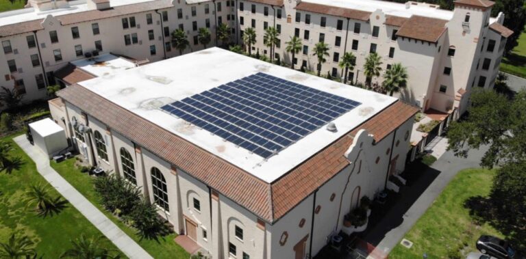 Aerial view of a solar array on a tile-roofed commercial building