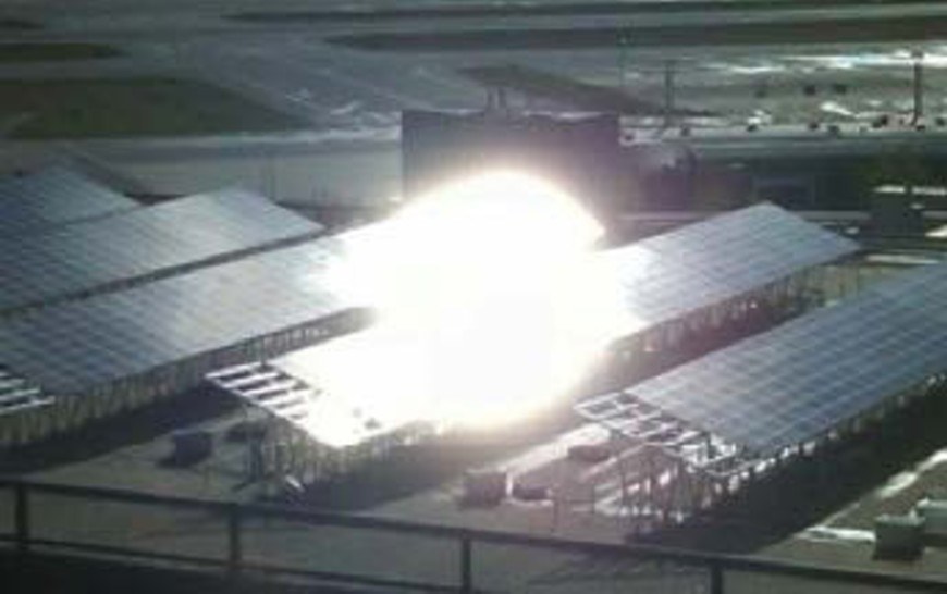Intense glare from solar canopies, seen from an airport control tower